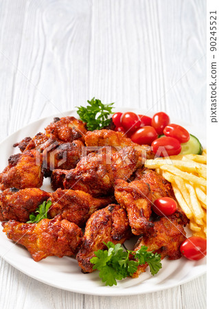roast chicken wings with french fries and veggies 90245521