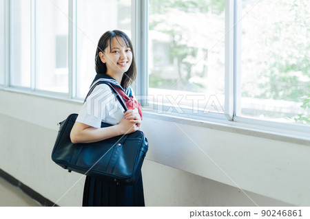 High school student walking in the school corridor 90246861