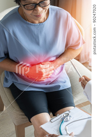 Abdominal pain in elder senior mature aging woman with stomachache illness from stomach cancer, irritable bowel syndrome, Indigestion, Diarrhea or GERD (gastro-esophageal reflux disease) 90247020