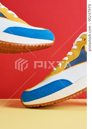 Flying trendy sneakers on creative colorful background, Stylish fashionable minimalism concept, Levitation shoes 90247979