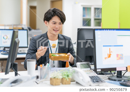 A businessman eating a lunch box using my chopsticks at the SDGs office A businessman eating a lunch box using my chopsticks at the SDGs office 90250879