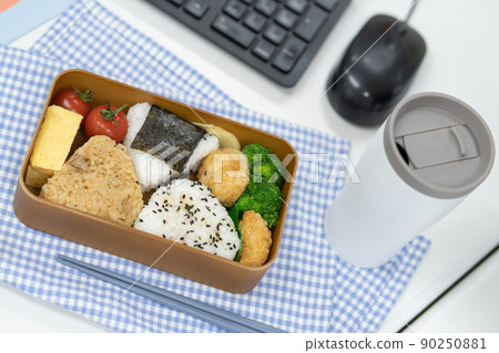 Rice ball lunch box and my chopsticks placed in front of the computer Rice ball lunch box and my chopsticks placed in front of the computer 90250881
