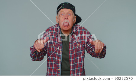Funny joyful man making playful silly facial expressions, grimacing, fooling around showing tongue Funny joyful man making playful silly facial expressions, grimacing, fooling around showing tongue 90252570