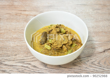 spicy boiled split grill mushroom with roash mackerel fish and Nitta tree seed or luk rieng in coconut milk curry soup Thai southern food on bowl 90252988