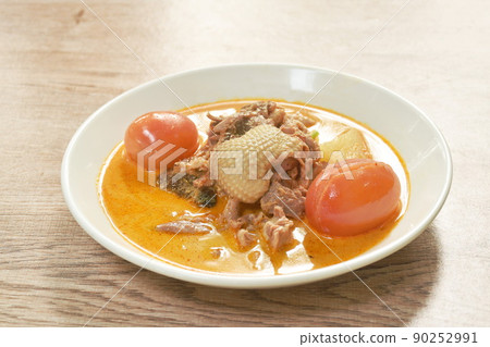 spicy boiled roasted duck meat with pineapple and tomato in coconut milk curry soup on plate 90252991
