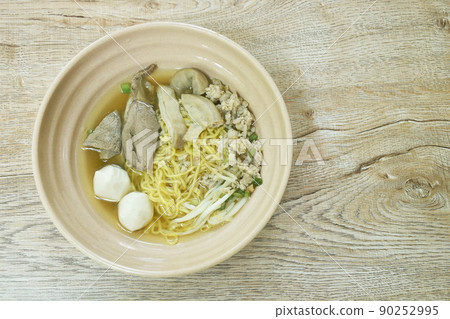 boiled Chinese yellow egg noodles with entrails and fish ball in soup on bowl boiled Chinese yellow egg noodles with entrails and fish ball in soup on bowl 90252995