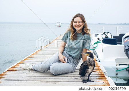 Beautiful young woman near the sea. Beautiful young woman near the sea. 90254799