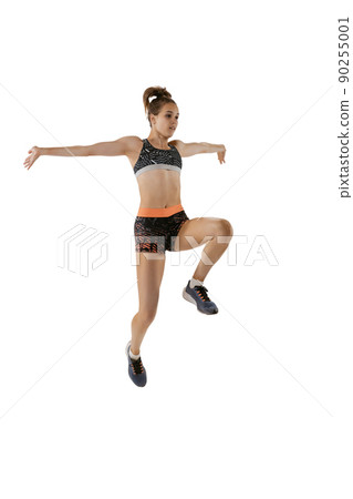 Long jump technique. Studio shot of professional female athlete in sports uniform jumping isolated on white background. Concept of sport, action, motion, speed. Long jump technique. Studio shot of professional female athlete in sports uniform jumping isolated on white background. Concept of sport, action, motion, speed. 90255001