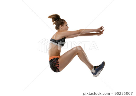 Long jump technique. Studio shot of professional female athlete in sports uniform jumping isolated on white background. Concept of sport, action, motion, speed. Long jump technique. Studio shot of professional female athlete in sports uniform jumping isolated on white background. Concept of sport, action, motion, speed. 90255007