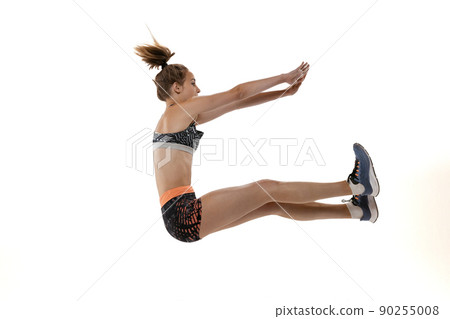 Development of movements in long jump sport. One professional female athlete in sports uniform jumping isolated on white background. 90255008