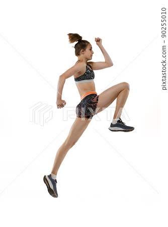Development of movements in long jump sport. One professional female athlete in sports uniform jumping isolated on white background. Development of movements in long jump sport. One professional female athlete in sports uniform jumping isolated on white background. 90255010