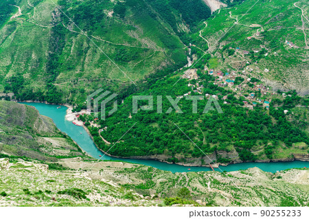 aerial view of the village of Old Zubutli in the valley of the Sulak River in Dagestan, small mountain settlement in a deep canyon with a jetty for motorboats aerial view of the village of Old Zubutli in the valley of the Sulak River in Dagestan, small mountain settlement in a deep canyon with a jetty for motorboats 90255233