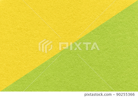 Texture of craft yellow and green paper background, half two colors, macro. Structure of vintage cardboard. 90255366