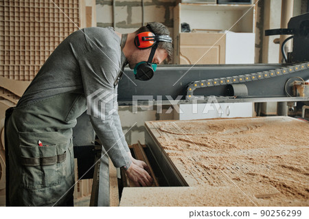 Worker Wearing Safety Gear in Shop 90256299
