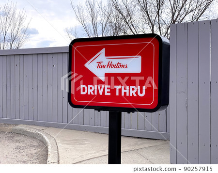 Calgary, Alberta, Canada. May 1, 2022. A Tim Hortons Drive Thru signage signal at a coffee shop.  90257915