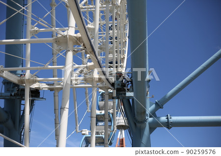 Ferris wheel. Amusement park with a big wheel for an overview of the city. Steel metal structure with cabins for people Ferris wheel. Amusement park with a big wheel for an overview of the city. Steel metal structure with cabins for people 90259576