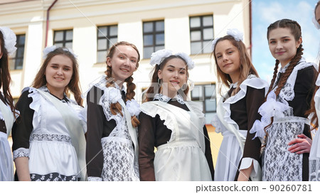 Smiling female graduates pose on the last day of school life. Smiling female graduates pose on the last day of school life. 90260781