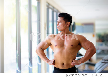 Man exercising in gym. Bodybuilder lifting weights Man exercising in gym. Bodybuilder lifting weights 90261259