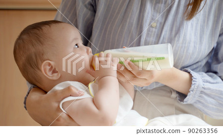 Mother giving milk to baby Mother giving milk to baby 90263356