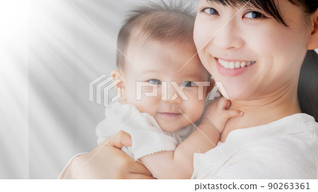 Mother hugging baby 90263361