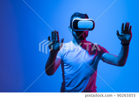 Modern architect, designer using virtual reality glasses at workplace. Designer working in augmented reality vr studio. Man working in VR goggles on a studio background. 90263855