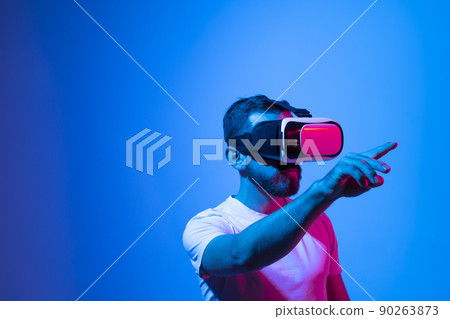 Modern architect, designer using virtual reality glasses at workplace. Designer working in augmented reality vr studio. Man working in VR goggles on a studio background. 90263873