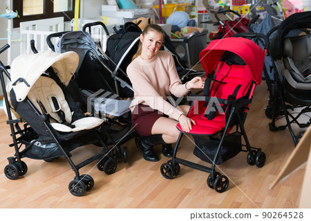 Adult mother buyer choosing stroller cane 90264528
