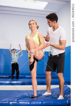People warming up before trampoline training 90264631