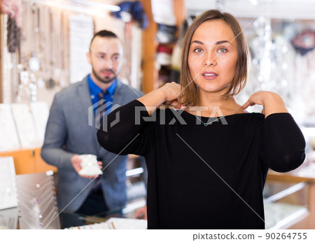 Woman customer trying chainlet with pendant 90264755