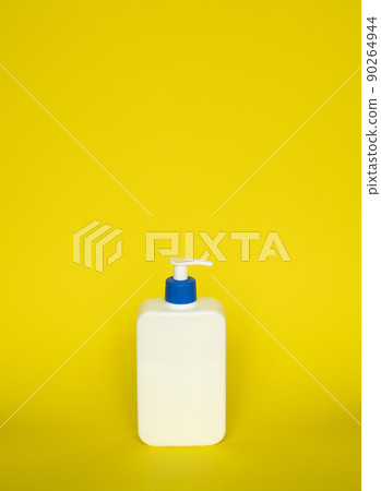 Liquid container for gel, lotion, cream, shampoo, bath foam. Cosmetic plastic bottle with blue dispenser pump on yellow background. Cosmetic packaging mockup with copy space. Liquid container for gel, lotion, cream, shampoo, bath foam. Cosmetic plastic bottle with blue dispenser pump on yellow background. Cosmetic packaging mockup with copy space. 90264944