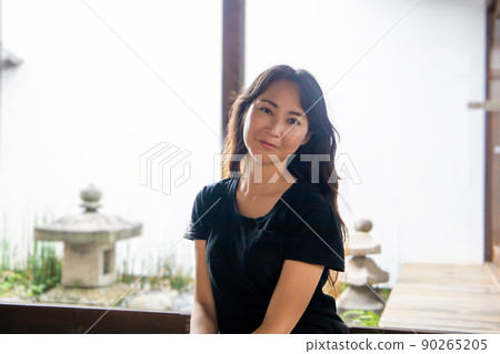 A woman smiling in an old folk house A woman smiling in an old folk house 90265205