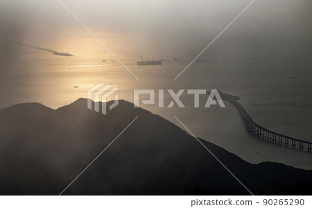Hong Kong Zhuhai Macau bridge in far view during foggy day and sunset 90265290