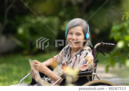 Music therapy in dementia treatment on elderly woman. 90267313