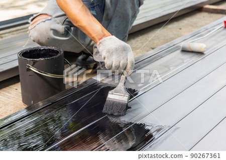 Worker painting steel post in construction site. Worker painting steel post in construction site. 90267361