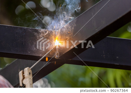 worker welding steel pipe in construction site 90267364