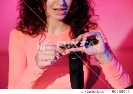 Young Caucasian female blogger recording sounds made with hair comb for tingles, ASMR video content Young Caucasian female blogger recording sounds made with hair comb for tingles, ASMR video content 90268965