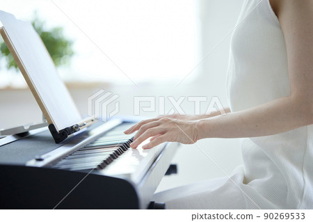 Japanese woman playing the piano in the living room 90269533