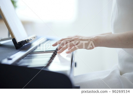 Japanese woman playing the piano in the living room 90269534