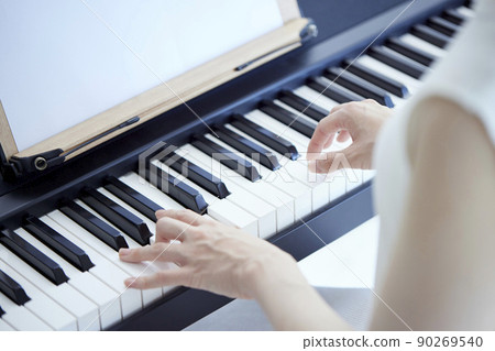Japanese woman playing the piano in the living room 90269540