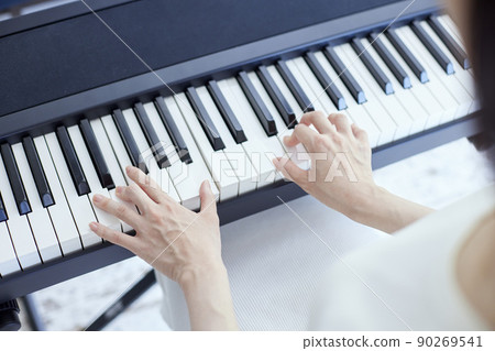 Japanese woman playing the piano in the living room 90269541