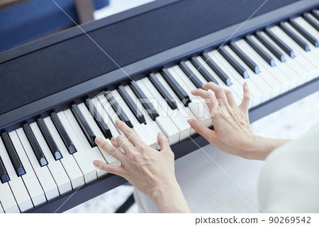 Japanese woman playing the piano in the living room 90269542