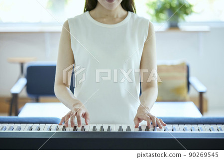 Japanese woman playing the piano in the living room 90269545