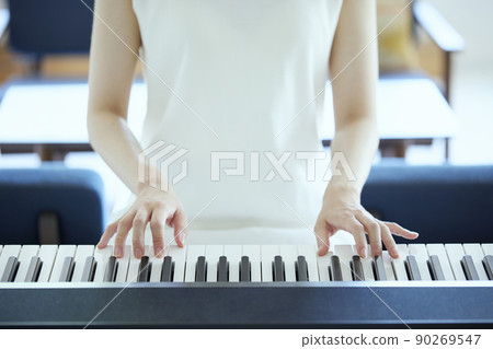 Japanese woman playing the piano in the living room 90269547