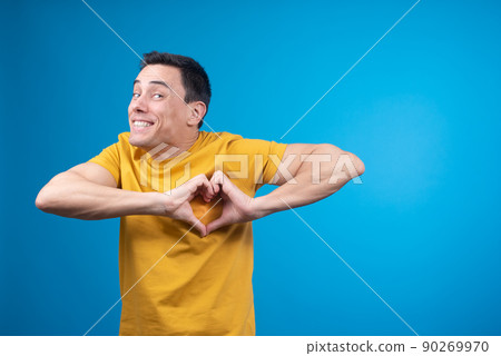 Happy man showing heart gesture in studio Happy man showing heart gesture in studio 90269970