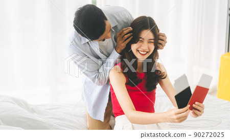 Man surprise to girlfriend with airplane ticket and passport couple ready for travel 90272025