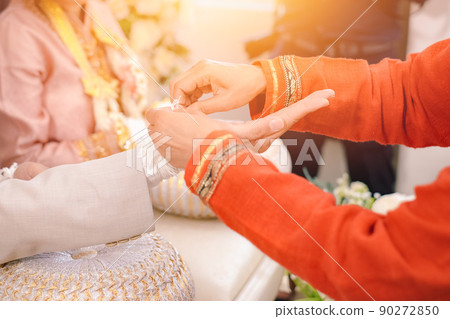 Asian Thai wedding culture of tie wrist holy threads and bless the newlyweds Asian Thai wedding culture of tie wrist holy threads and bless the newlyweds 90272850