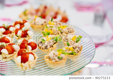 canapes on a plate. catering services for the banquet. convenient small snacks. 90273213