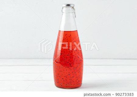 Basil seed drink in glass bottle on white background Basil seed drink in glass bottle on white background 90273383