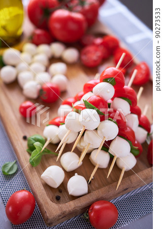 Caprese salad - Mini mozzarella cheese in glass bowl, tomato and basil Caprese salad - Mini mozzarella cheese in glass bowl, tomato and basil 90273533