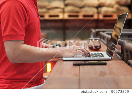 Casual Businessman using smartphone and laptop, freelance man typing keyboard computer notebook in cafe or modern office. technology, digital online and network concept Casual Businessman using smartphone and laptop, freelance man typing keyboard computer notebook in cafe or modern office. technology, digital online and network concept 90273869